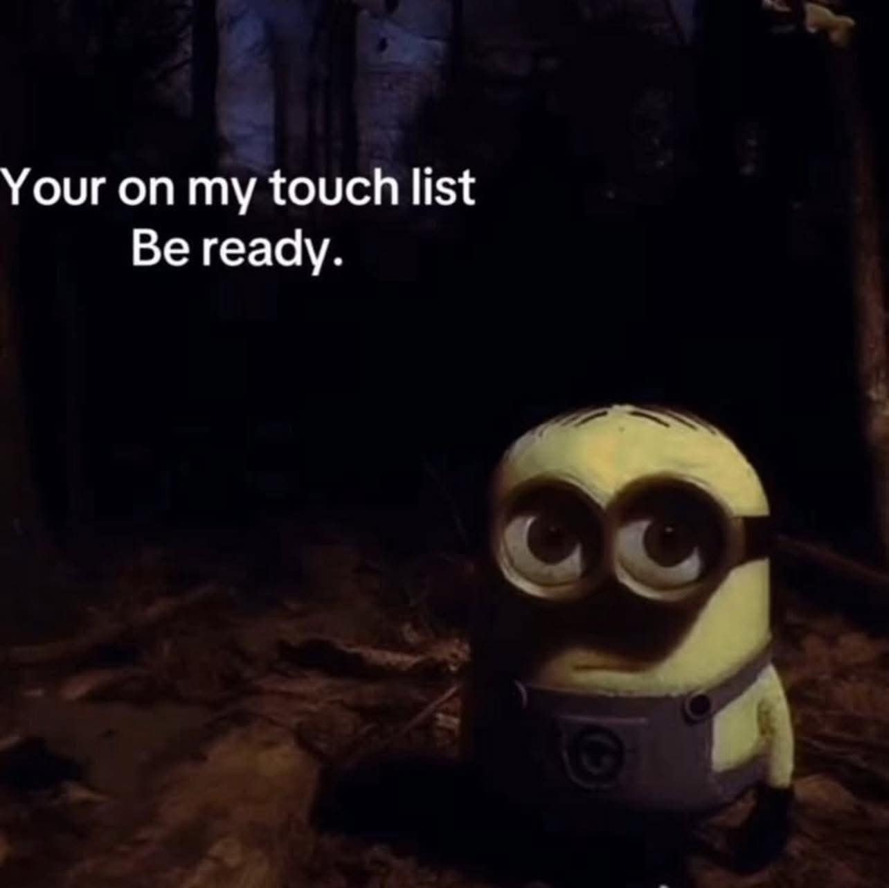 Creepy minion in dark woods with strange caption