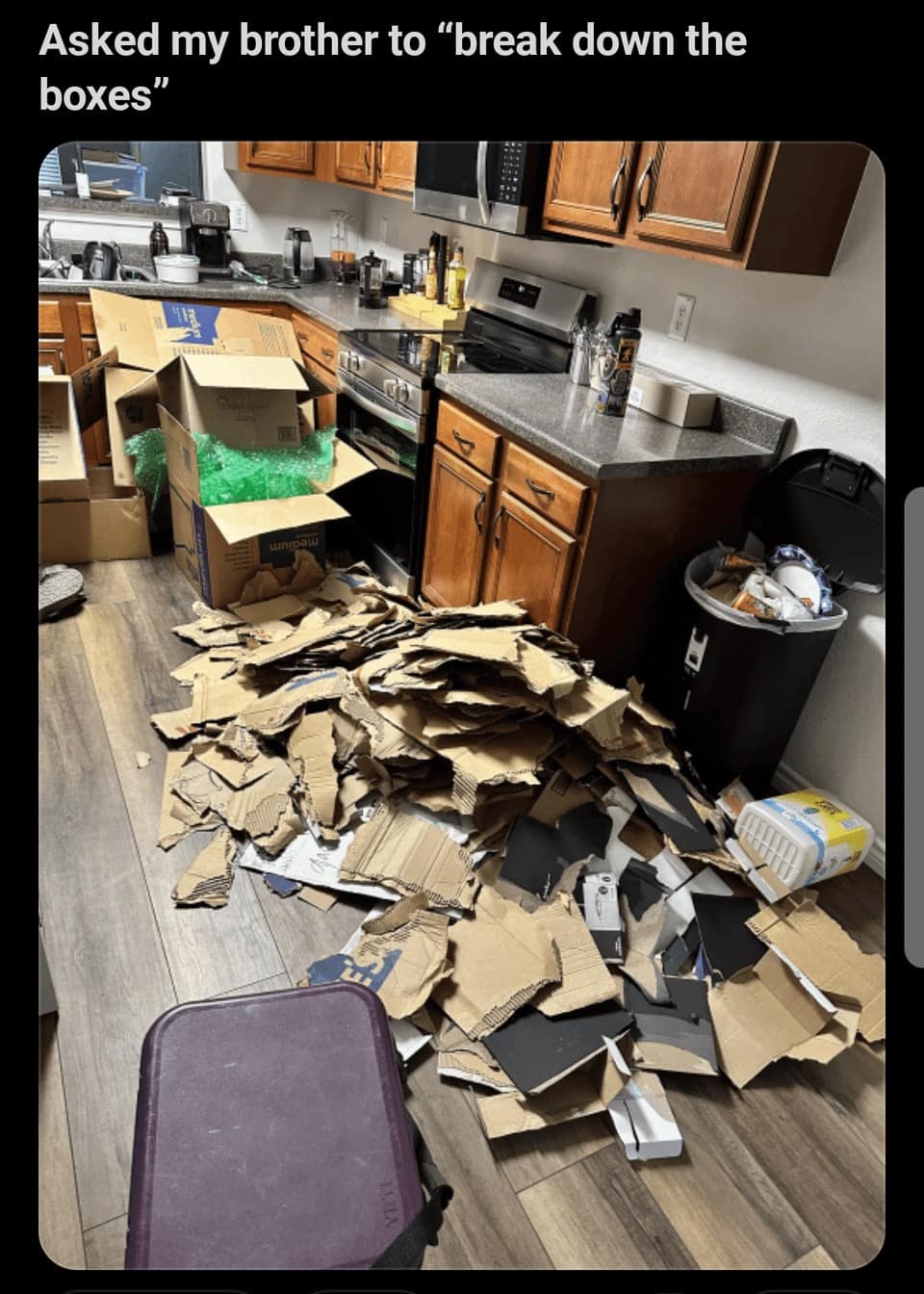 Torn cardboard boxes scattered on kitchen floor