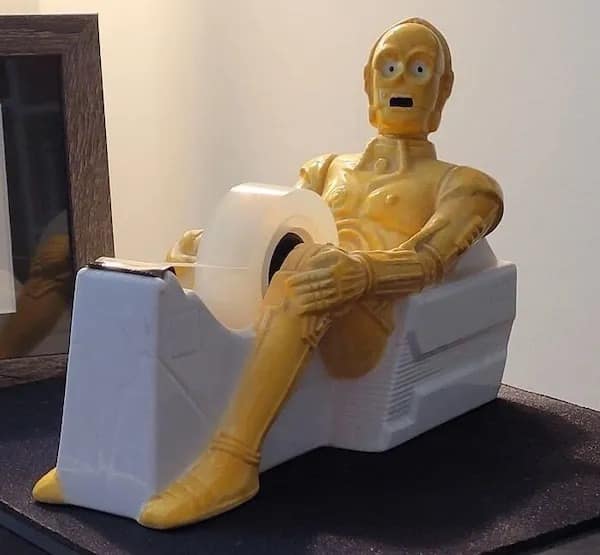 C-3PO-shaped tape dispenser with a shocked expression