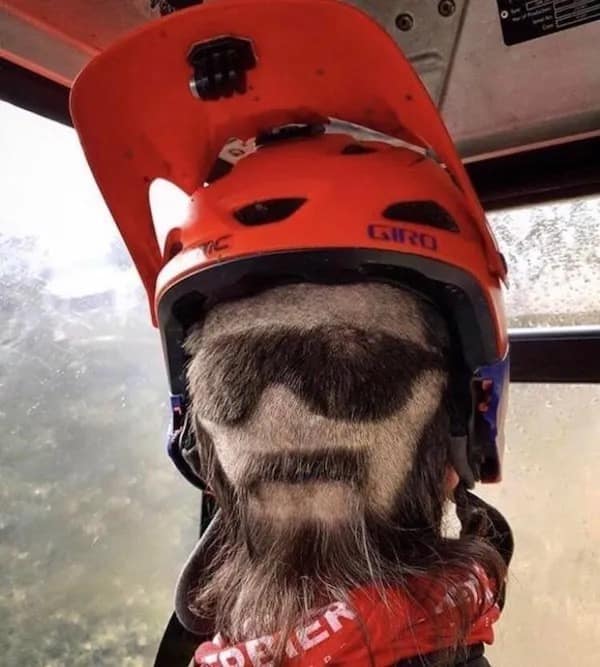 Man’s beard shaved into a face wearing sunglasses
