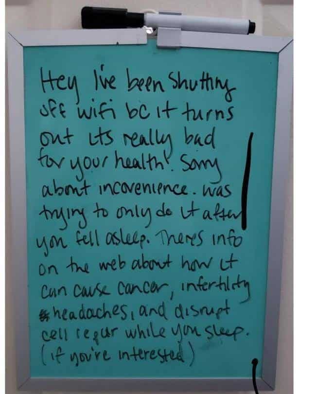 A handwritten whiteboard note from a roommate who is turning off the WiFi for health reasons.