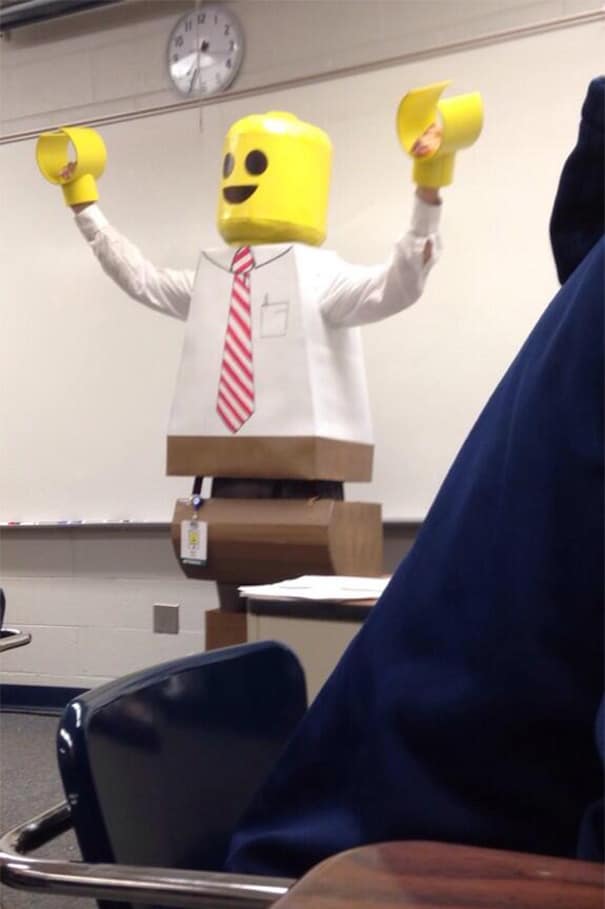 Educator wearing a homemade LEGO minifigure costume at the front of the class.