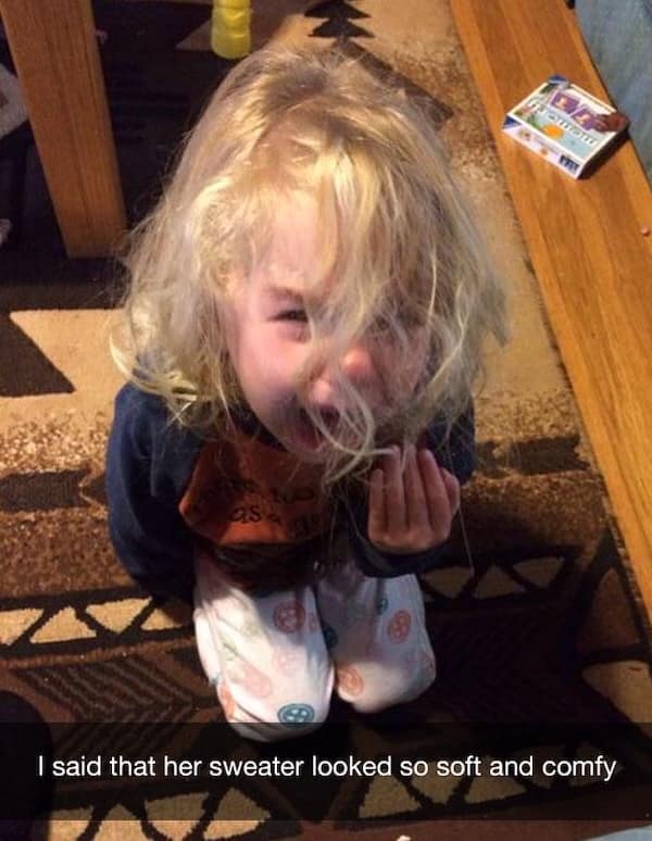 Toddler crying on the floor after a compliment about her sweater