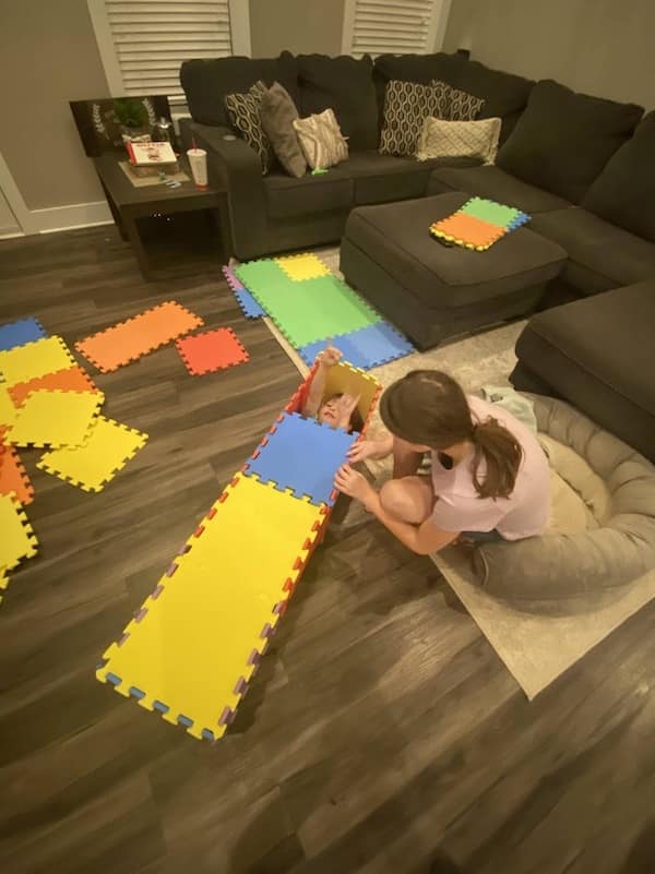 Kids breaking things by taking apart foam floor tiles to build a slide in the living room.
