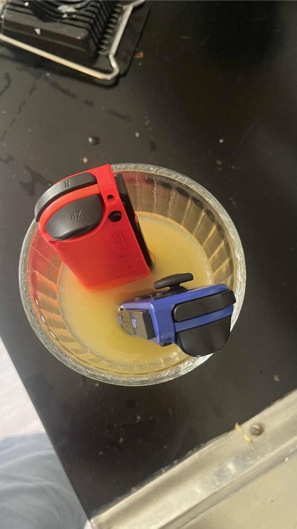 A painful photo of kids breaking things by soaking Nintendo Switch controllers in orange juice.