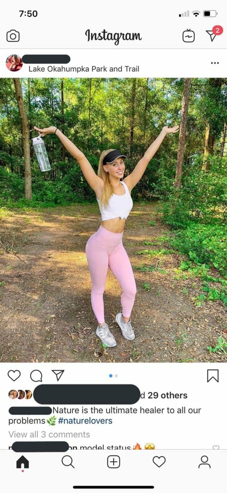 An Instagram influencer poses in pink leggings, pretending to be a nature lover on a scenic trail.