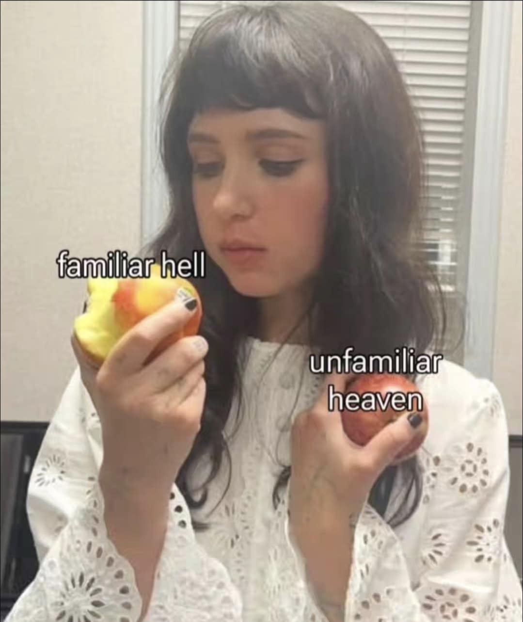 Woman holding two fruits labeled “familiar hell” and “unfamiliar heaven,” pondering her choice.