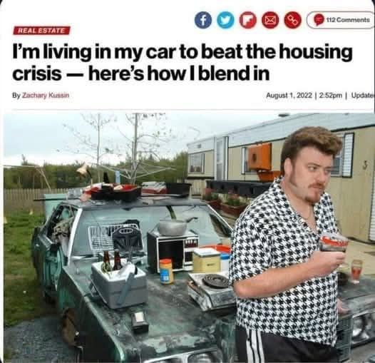 parody news headline about living in a car to beat the housing crisis with a man beside a junk-covered vehicle.