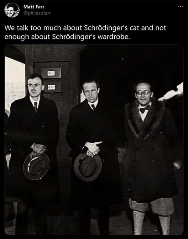 Vintage photo of physicists; caption praises Schrödinger’s fur-collared coat.