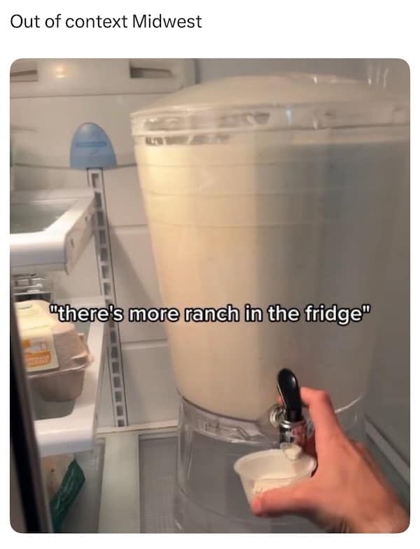 Large drink dispenser filled with ranch dressing inside a refrigerator with the text “there’s more ranch in the fridge.”