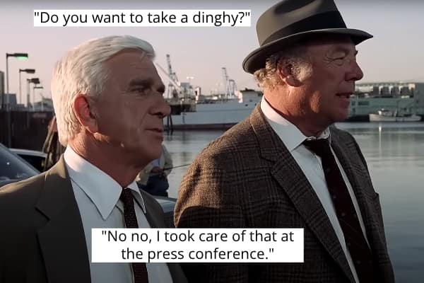 Leslie Nielsen misinterprets "dinghy" at a press conference, standing by a pier.