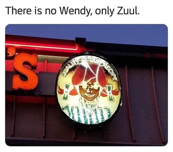 Damaged, over-lit Wendy’s sign that makes the mascot’s face look demonic; caption: “There is no Wendy, only Zuul.”