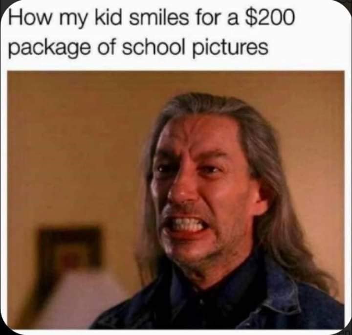 Close-up of a long-haired man grimacing with clenched teeth; caption about school picture day.