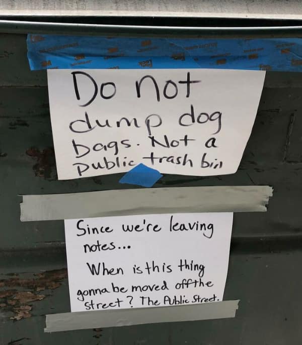 Passive aggressive neighbour notes battling on the side of a dumpster about dog poop.
