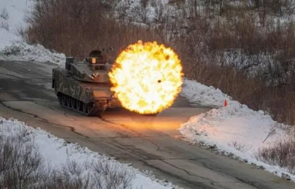 Battle tank firing, captured with a circular fireball muzzle blast