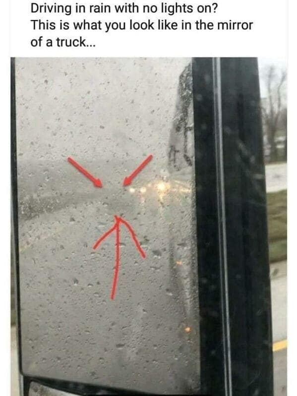 Red arrows point at a faint light in the reflection of a truck’s side mirror.