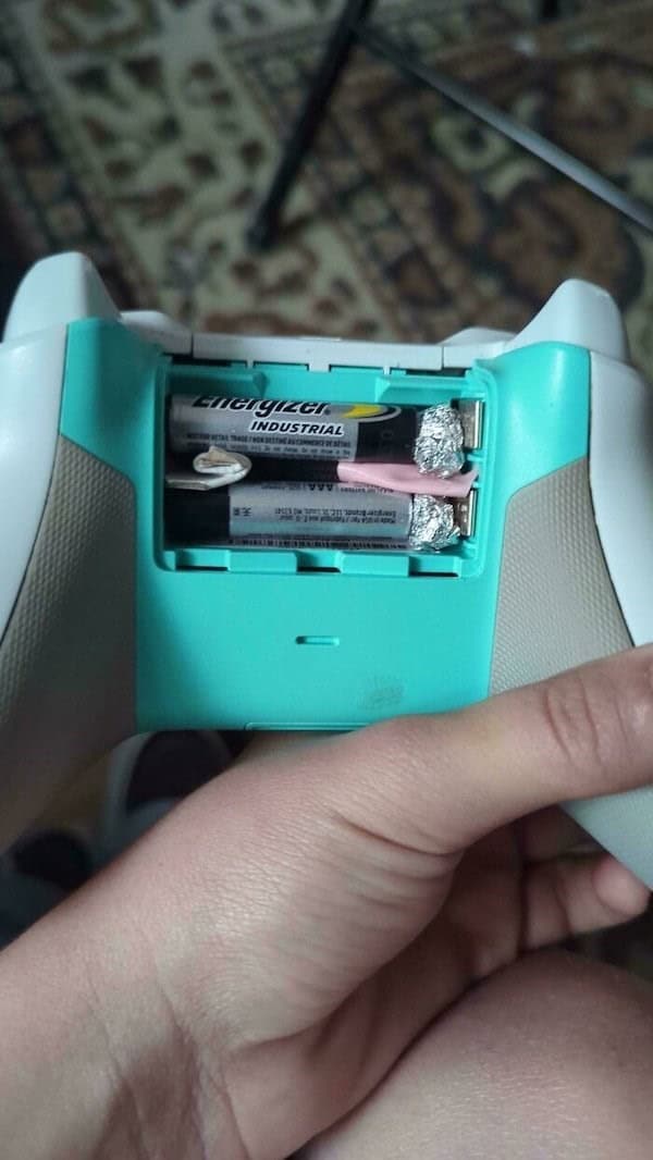 An example of redneck engineering using aluminum foil to make smaller batteries fit in a controller.