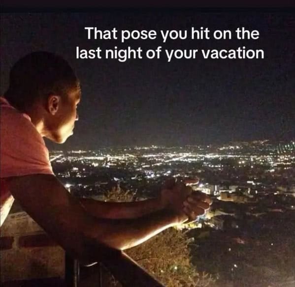 Person leaning on a balcony at night, staring over a glowing city with the caption “That pose you hit on the last night of your vacation.”