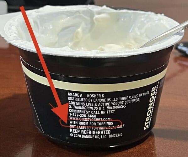 A yogurt cup shrinkflation example using the text "with room for toppings" to justify less yogurt.