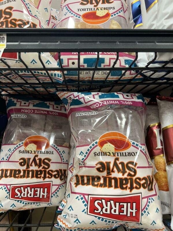 Bags of Herr's tortilla chips that are mostly filled with air, a common shrinkflation example.