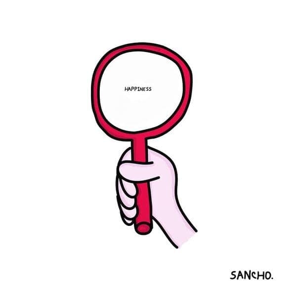 Hand holding a round mirror with the tiny word happiness in the center