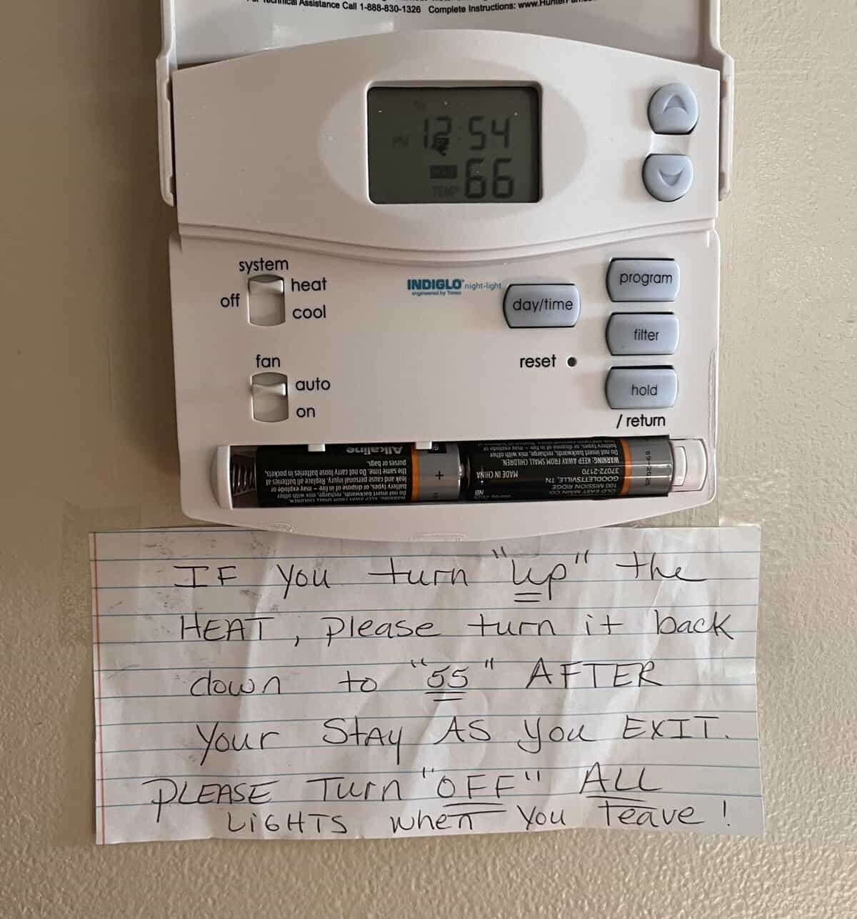 Thermostat with handwritten sign using awkward quotes around “up” and “off”