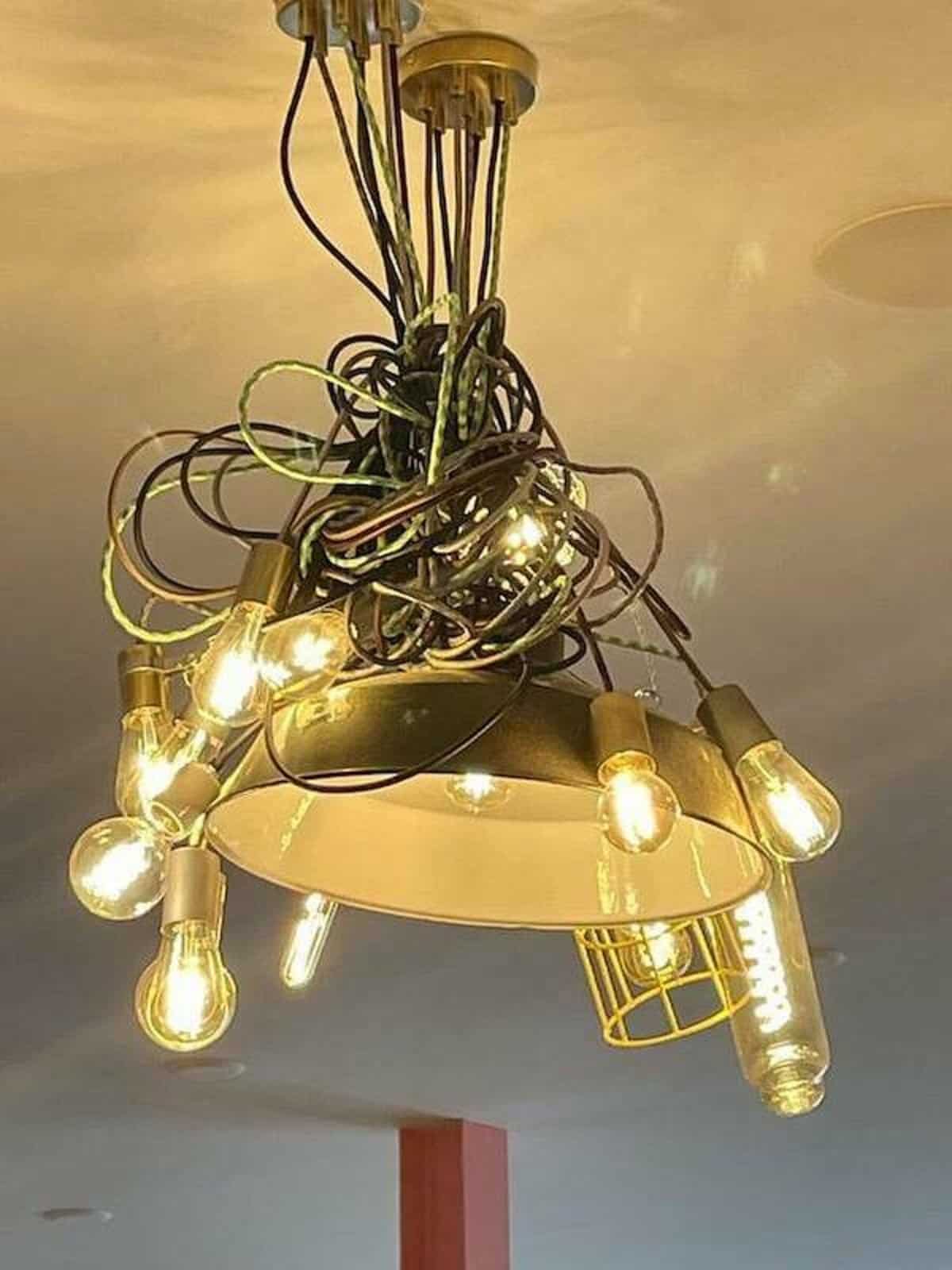 Tangled chandelier light fixture with exposed wires and bulbs