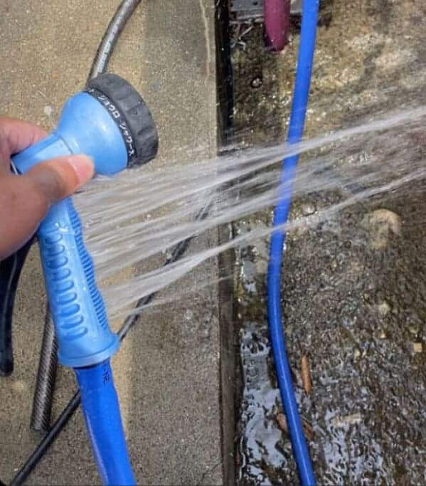 Broken hose nozzle spraying water sideways instead of forward