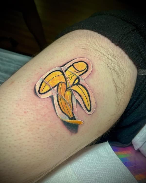 A tattoo of a peeled banana with a sad expression, covered in translucent tape.