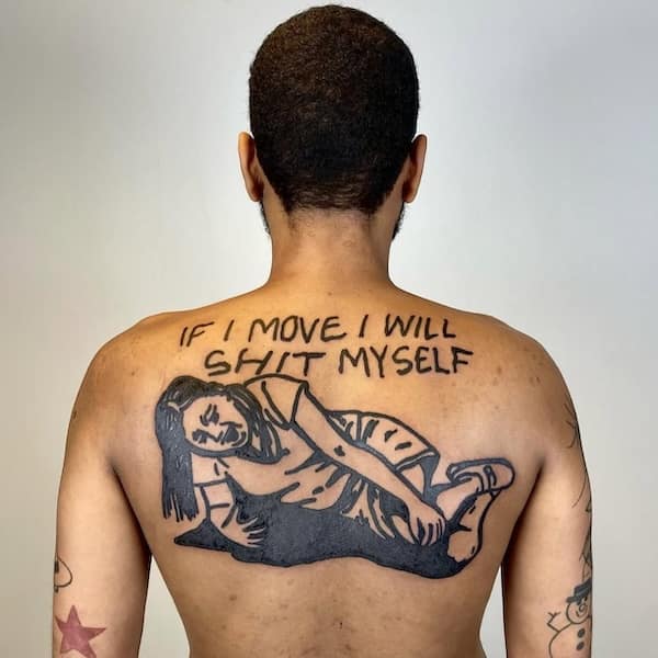 A large tattoo on a man’s back of a woman lying down, with the caption “IF I MOVE I WILL SHIT MYSELF.”