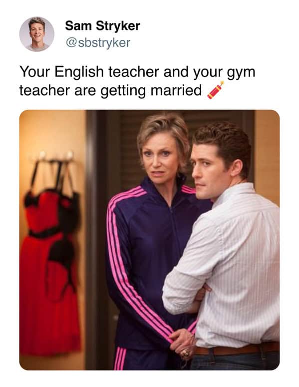 Two adults stand together; one wears a purple tracksuit, one a shirt.