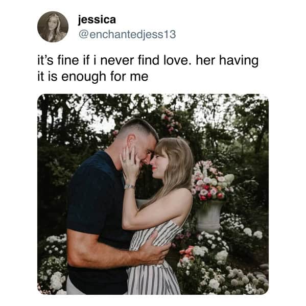 Couple touch foreheads in flower-filled garden, hands on cheeks.