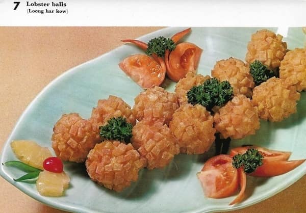 A retro recipe photo of deep-fried, cube-textured "Lobster balls" arranged on a platter.
