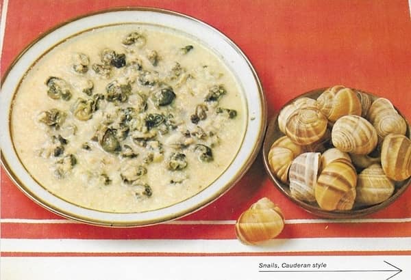 A retro food photo of a creamy snail soup next to a separate bowl of shells.