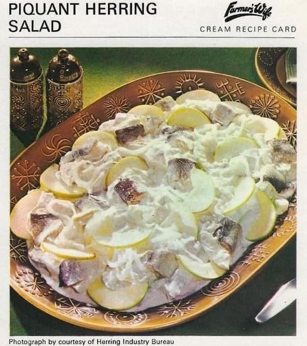A vintage recipe for "Piquant Herring Salad" with chunks of herring, apple, and cream.