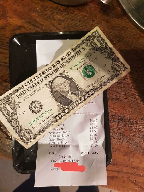 One of the worst server tips showing a single US dollar on a £38 bill in the UK.