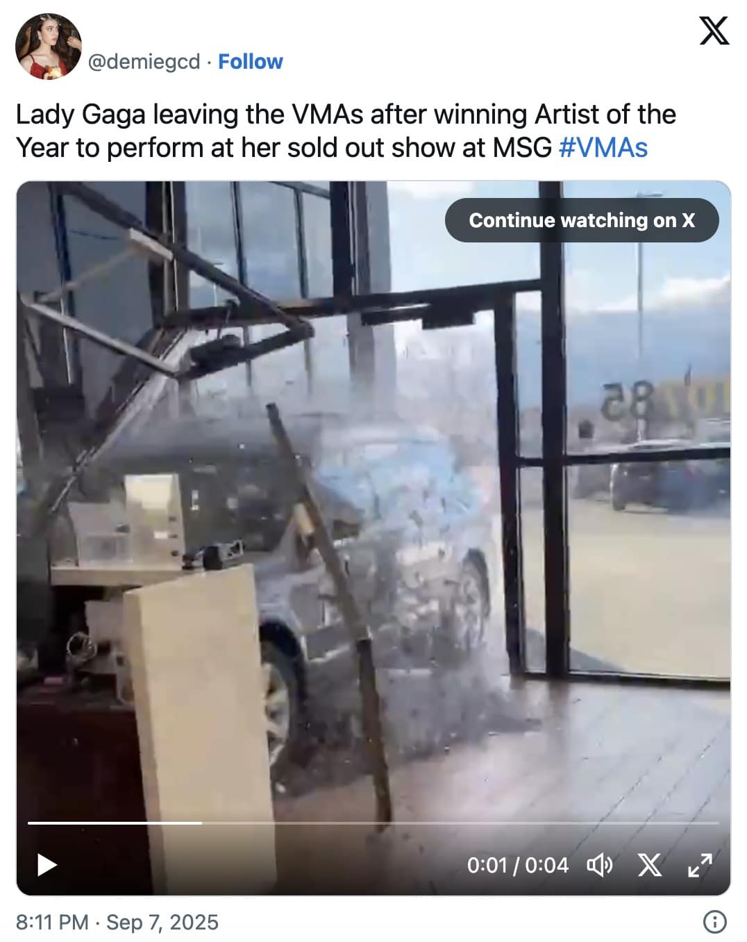 Security camera view of a car bursting through a glass storefront
