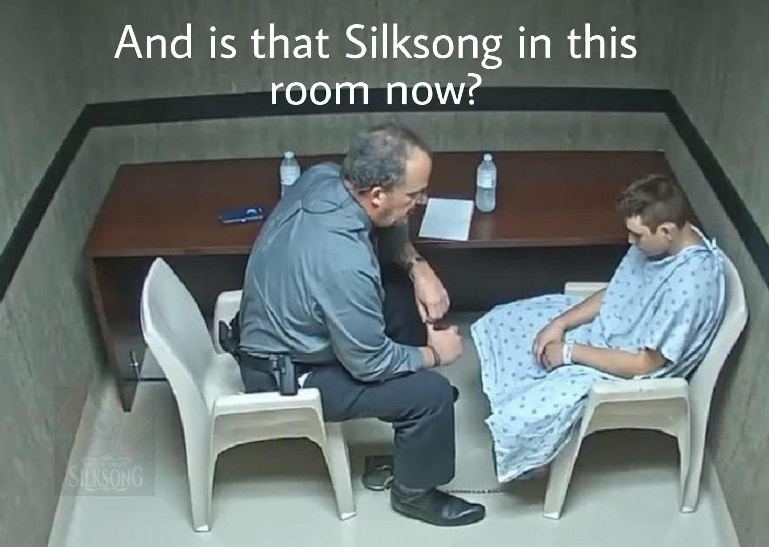 Interrogation-room Silksong meme with a detective asking a slumped man, “And is that Silksong in this room now?”