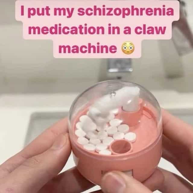 A funny and creative image of a person who has put their schizophrenia medication inside a tiny toy claw machine in order to gamify taking their daily pills.