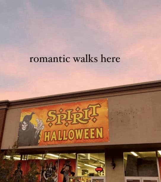An image of a Spirit Halloween store with text overlaid that reads "romantic walks here."
