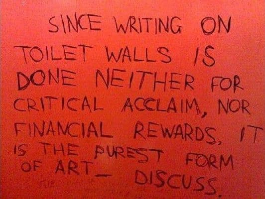 A profound and philosophical message that has been written on a red bathroom wall, which argues that bathroom graffiti is actually the "purest form of art."