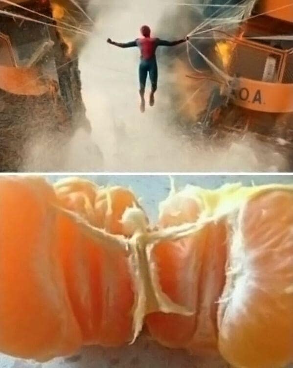 A blursed image comparing Spider-Man holding two ferries together to a peeled orange.