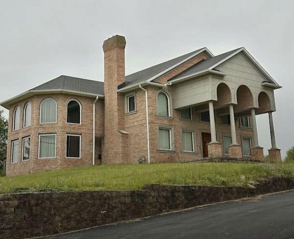 A classic construction fail of a McMansion with too many conflicting architectural styles and windows.