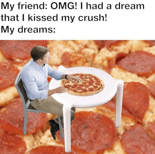 Man seated at a giant plastic pizza saver, eating a small pepperoni pizza.