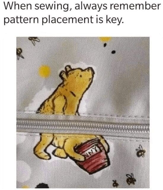 Fabric print of a yellow bear split awkwardly by a zipper with caption about pattern placement