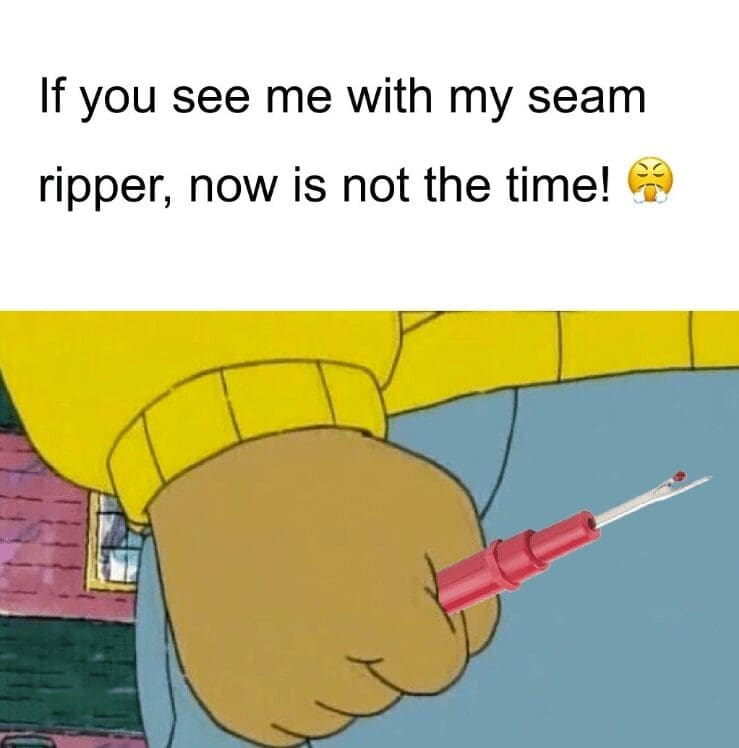 Cartoon clenched fist edited to hold a red seam ripper with warning caption