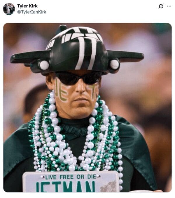 A dedicated New York Jets superfan with a custom jet helmet, face paint, and a "JETMAN" license plate.