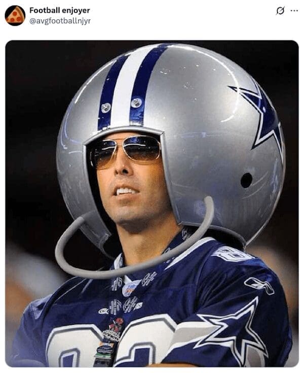 A crazy Dallas Cowboys fan wearing a massive, oversized novelty football helmet and sunglasses in the stands.