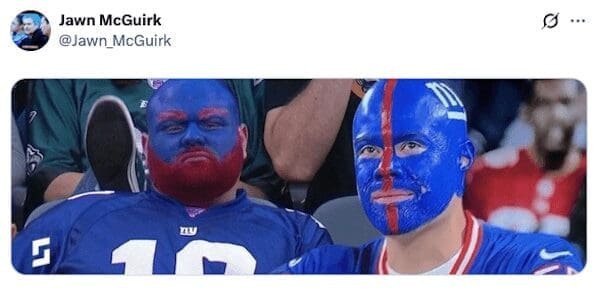 Two dedicated New York Giants fans who have their entire faces and even their beards painted blue and red.