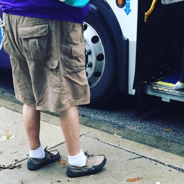 An ambitious dad fit that boldly combines comfortable khaki cargo shorts with white socks and boat shoes.